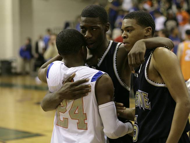 Elijah Johnson and Demtric Williams of Cheyenne fight back the tears as they congratulate John Loyd after the game as Bishop Gorman and Cheyenne faced off in the Sunset Regional semifinals at Palo Verde High School in Las Vegas Thursday night.  Bishop Gorman pulled out a victory over Cheyenne 70-68.