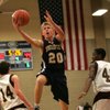 Boulder City senior Joey Western (20) drops in a point over Faith Lutheran defenders during the 3A Southern League basketball tournament at Desert Oasis High on Feb. 19.