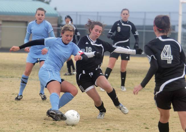 Centennial's Julie Owens fights for control of the ball against a Palo Verde player during a game at Centennial High School on Feb. 9.  