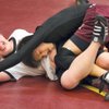 Billy Wolfbrandt, left, has fun wrestling with teammate Danny Chung, right, during practice at Faith Lutheran Middle School.