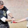 Al Kermode, left, coach of the Little League team the Diamond Backs, gives some batting tips to Bradley Henderson, 11, during a morning practice at the Boulder City Veterans Memorial Park.