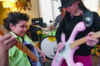 Joei, 12, right, and bother Jesse Fulco, 10, rehearse at their home.