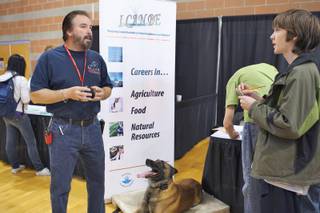 Foothill freshman Richard Phillips interviews dog trainer Alfredo Rivera, president of Sit Means Sit, during the I Can Be Career Expo hosted by the Henderson Chamber of Commerce at Foothill High School.
