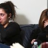 Elizabeth Sarkisian, left, 16, and sister Michelle, 17, wipe away tears as they talk about their mot