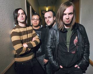 Members of the band Searchlight, from right, Adams Michaels, Kevin Abdon, Ricky Torres and Matt Hopkins pose at their rehearsal room.