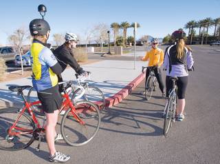 Jackie Arcana (in orange) reviews some safety tips before leading a bike ride.