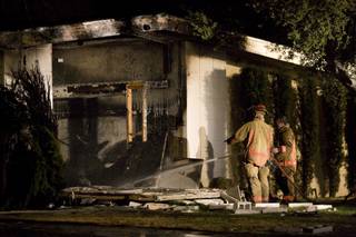 City of Las Vegas firefighters wrap up extinguishing a fire that followed an explosion at a home at 2601 Mason Ave. Fire officials said arson might be to blame in the incident. Neighbors reported the blaze at about 8:30 p.m. Thursday.