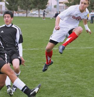Las Vegas Premier player Shane Panther, right, soars after a shot attempt against the Nevada Devils during the U-17 finals in the NYSA's Silver State Tournament held at Bettye Wilson Sports Complex.