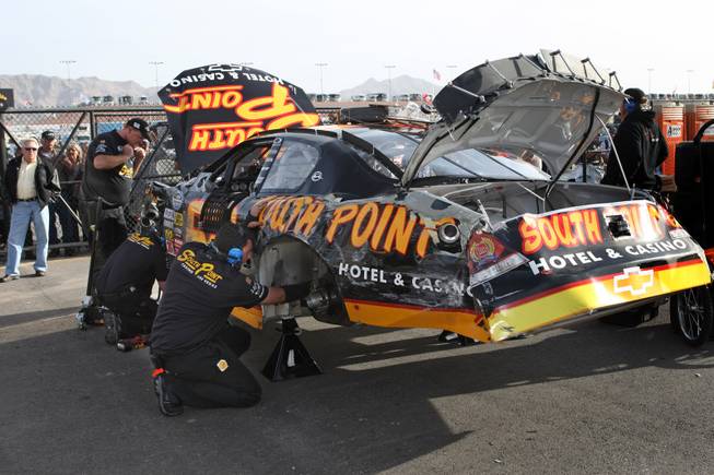 Crew members work on Brendan Gaughan's car after the Las Vegas native hit the wall during the second practice session for Saturday's Sam's Town 300 at the Las Vegas Motor Speedway on Friday.