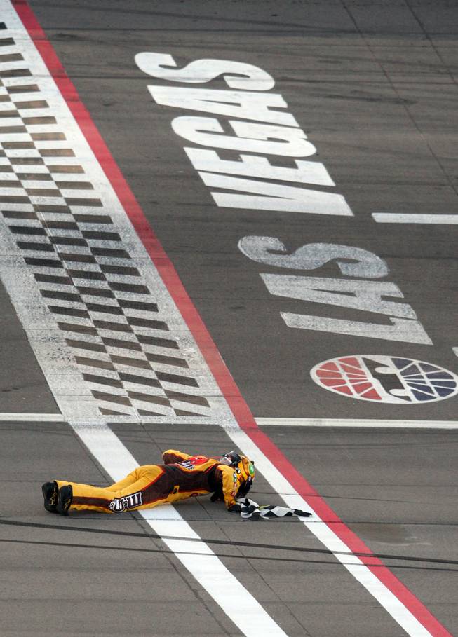 Las Vegas native Kyle Busch (18) kisses the finish line after winning the 2009 Shelby 427 NASCAR Sprint Cup Series race at the Las Vegas Motor Speedway on Sunday.