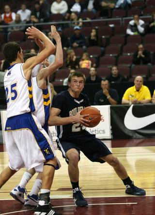 Boulder City's Shane Levin (24) looks for a shot against Moapa Valley defenders during the 3A state finals at the Orleans Arena Saturday.
