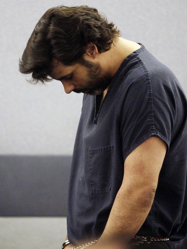 Harold Montague, accused of an assault with a medieval-style battle ax that killed a baby, hangs his head as he appears for an arraignment hearing at the Regional Justice Center, Wednesday, March 3, 2010.