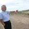Photo: Pastor John Ritenour looks over a dirt plot at Geo