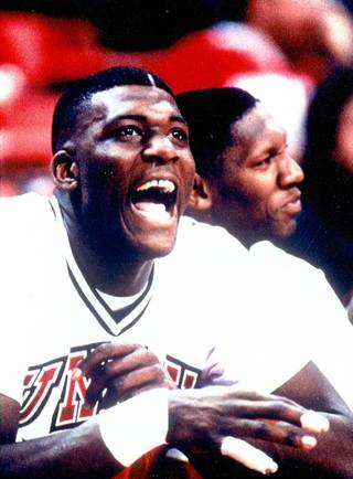 UNLV great Larry Johnson cheers on his teammates from the Rebels bench. Johnson led the Rebels to a NCAA title and another Final Four appearance. 