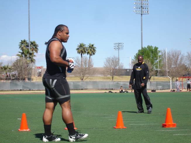 Former UNLV running back Frank Summers takes a drink and a breather between cone drills orchestrated by Pittsburgh Steelers running backs coach Kirby Wilson. The Steelers were one of 12 NFL franchises that tested Summers and several other graduating Rebels on Thursday morning.