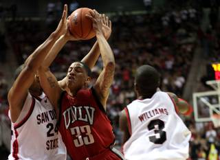 Tre'Von Willis goes to the basket by two defenders during  first-half action as the Rebels take on the San Diego State Aztecs Saturday night, March 7, 2009, at Cox Arena in San Diego.  UNLV lost 57-46 to finish the regular season 9-7 in conference play.

