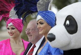 Las Vegas Mayor Oscar Goodman, showgirls Meda Bell, left, Candice Dickerson and the World Wildlife Fund panda mascot pose for photos before a 2010 Earth Hour news conference at the Welcome to Fabulous Las Vegas sign Tuesday, March 9, 2010. Earth Hour will take place on March 27 at 8:30 p.m. Las Vegas time. For the second year in a row, casinos on the Las Vegas Strip will turn off marquee and non-essential exterior lighting for the event.