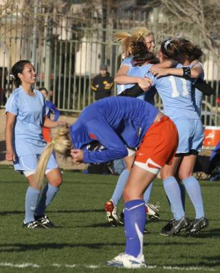 As Centennial High School's players, in light blue, celebrate their 2-0 victory at the Sunset Regional championship Monday, Bishop Gorman's Cassie Downs, foreground, tries to hide the tears of defeat.