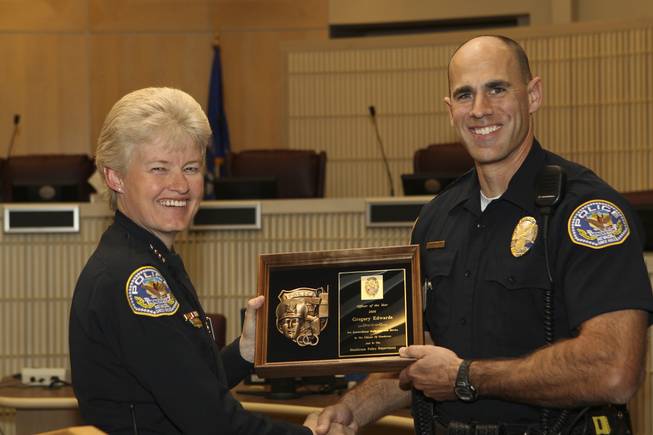 Recognized as an officer who exemplifies professionalism, dedication and honesty, Officer Greg Edwards receives the highest award of Officer of the Year from Henderson Police Chief Jutta Chambers Wednesday during the 6th Annual Commendation Award Ceremony.  During his 12 years of service on the police department, Edwards has taken on many leadership roles and is highly respected amongst his peers and supervisors in his abilities and dedication as a phenomenally skilled officer.