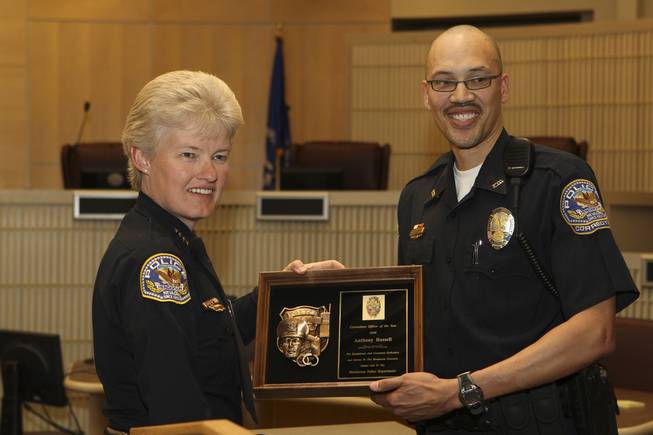 Recognized for his dedication to go the extra mile, Corrections Officer Anthony Russell receives the Corrections Officer of the Year Award from Henderson Police Chief Jutta Chambers Wednesday during the 6th Annual Commendation Award Ceremony.