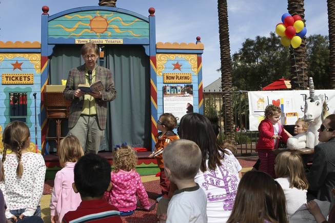 Magician Mac King entertains a plaza full of children while reading "Sideways Stories From Wayside School" by Louis Sachar during storytime Wednesday in Town Square plaza in celebration of National Reading Month.