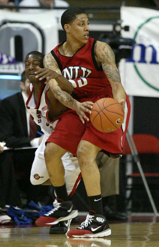 UNLV's Tre'Von Willis gets fouled by San Diego State guard Richie Williams during their game at the Mountain West Conference basketball championships on March 12.