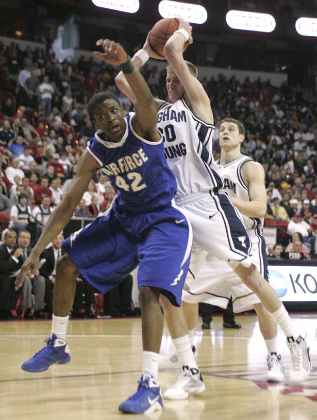 BYU guard Lee Cummard pulls a rebound away from Air Force forward Anwar Johnson at the Mountain West Conference Basketball Championships Thursday, March 12, 2009.  BYU won the game 80-69. SAM MORRIS / LAS VEGAS SUN