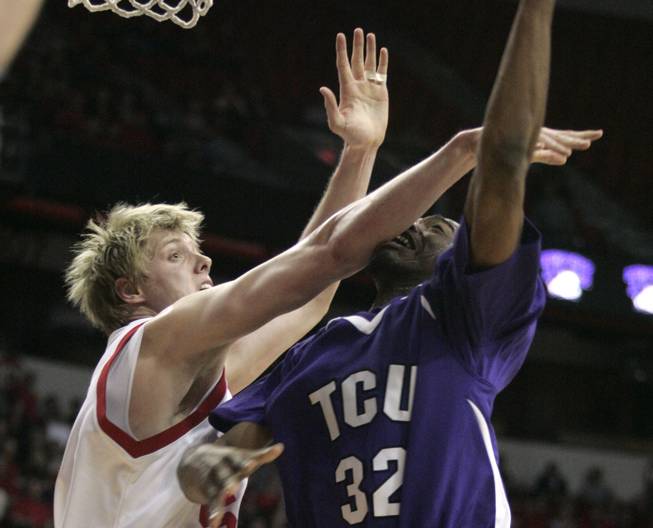 Utah center Luke Nevill fouls TCU forward Kevin Langford during their game at the Mountain West Conference Basketball Championships Thursday, March 12, 2009.  Utah won the game 61-58 on a last-second three point shot. 