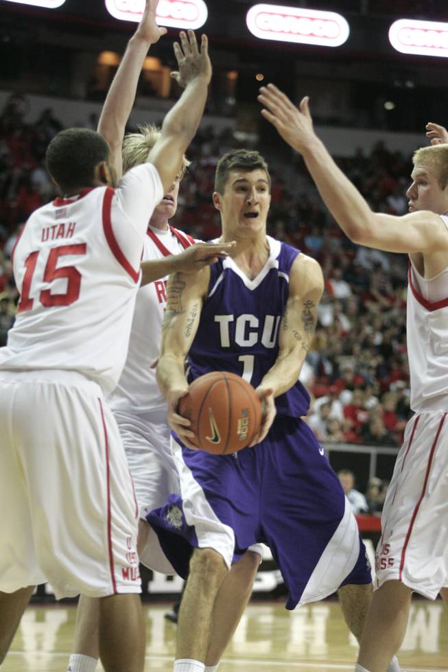 TCU forward Zvonko Buljan looks to pass while being surrounded by Utah players, from left, Carlon Brown, Luke Nevill and Shaun Green during their game at the Mountain West Conference Basketball Championships Thursday, March 12, 2009.  Utah won the game 61-58 on a last-second three point shot.