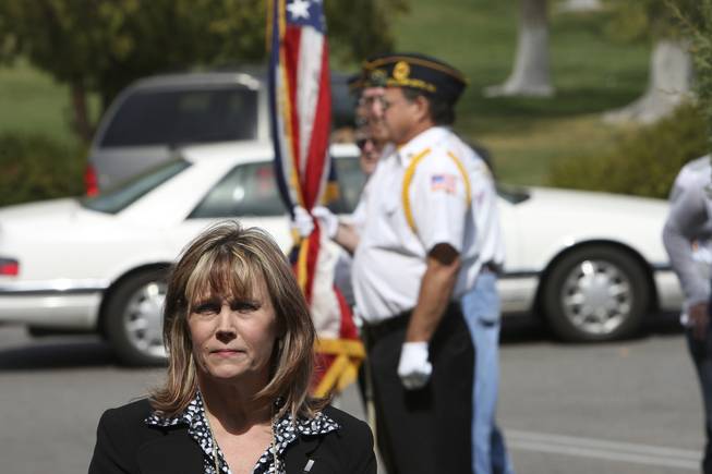 With the American Legion Post 31 Color Guard in the background, Shirley Roland waits to be sworn in as the new postmaster of Boulder City during an installment ceremony Thursday in Boulder City.