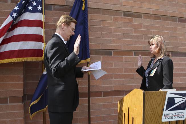 Shirley Roland takes the oath of office as the new postmaster of Boulder City given by Craig Colton, manager of post office operations, during the installment ceremony Thursday in Boulder City.