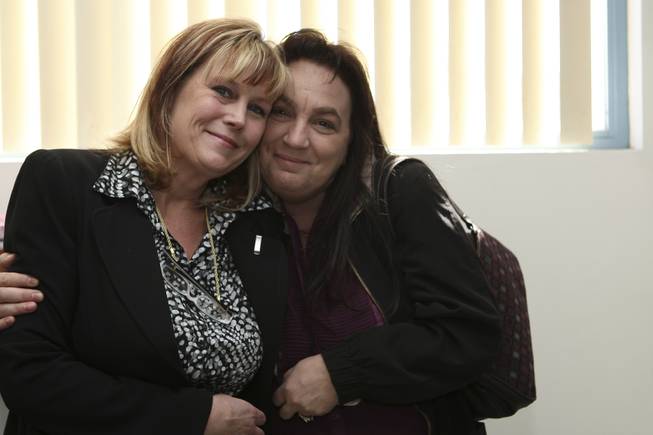 Postmaster Shirley Roland receives a congratulatory hug from longtime co-worker and friend, Cheri Ward, right, during her installment ceremony reception Thursday in Boulder City.