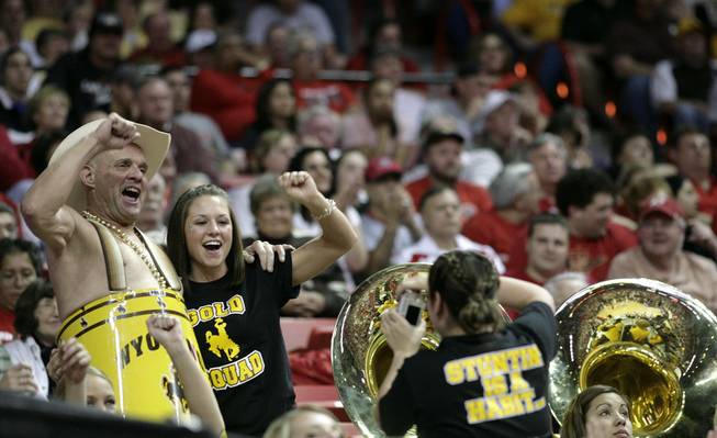 A member of the Wyoming band poses with a fan as New Mexico takes on Wyoming on Thursday in the Mountain West Conference tournament at the Thomas & Mack Center. 