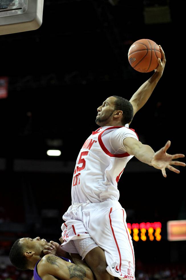 Lawrence Borha skies in for the jam as Utah takes on TCU on Thursday in the Mountain West Conference tournament at the Thomas & Mack Center. Utah eeked out the win 61-58.