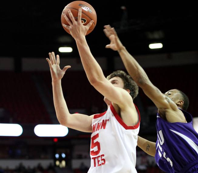 Luca Drca lays it in past the outstreched arms of the defender as Utah takes on TCU on Thursday in the Mountain West Conference tournament at the Thomas & Mack Center. Utah eeked out the win 61-58.