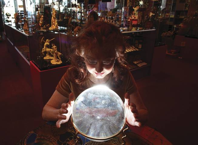 Psychic Shandara Cook looks into a crystal ball last week at the Psychic Eye Book Shop on South Eastern Avenue.
