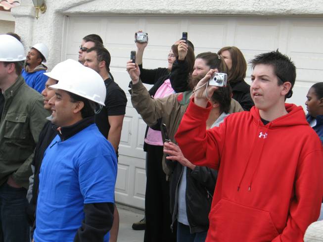 Volunteers and onlookers attempt to snap photos of the "Extreme Makeover: Home Edition" host Ty Pennington, during the demolition of the Cerda family's home Thursday.