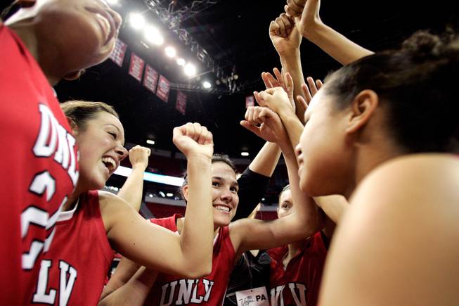 The UNLV women's basketball team celebrates their 84-75 win over Texas Christian University during the quarterfinals of the Mountain West Championship on Wednesday at the Thomas & Mack Center.