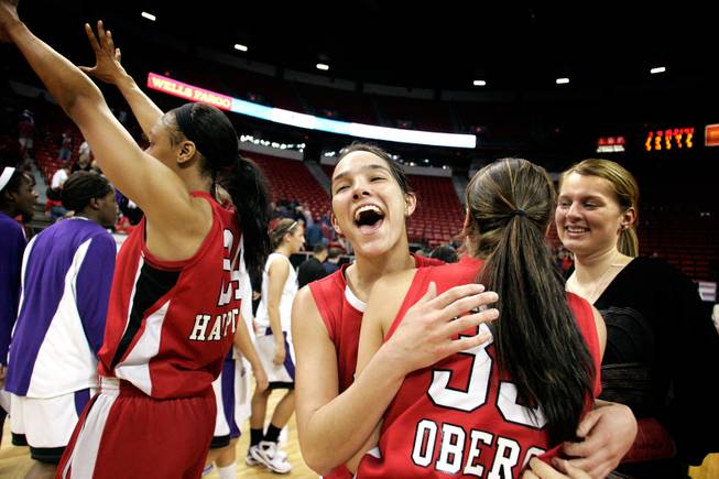  Jamie Smith, center, and Shannon Oberg of UNLV celebrate their 84-75 win over Texas Christian University during the quarterfinals of the Mountain West Championship on Wednesday at the Thomas & Mack Center.