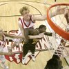 Utah center Luke Nevill leaps over Wyoming forward Tyson Johnson to reach a rebound during their semifinal game at the Mountain West Conference Basketball Championships Friday. Utah won 68-55 and will face San Diego State Saturday for an automatic trip to the NCAA Tournament. Nevill finished with a game high 23 points and 15 rebounds. 