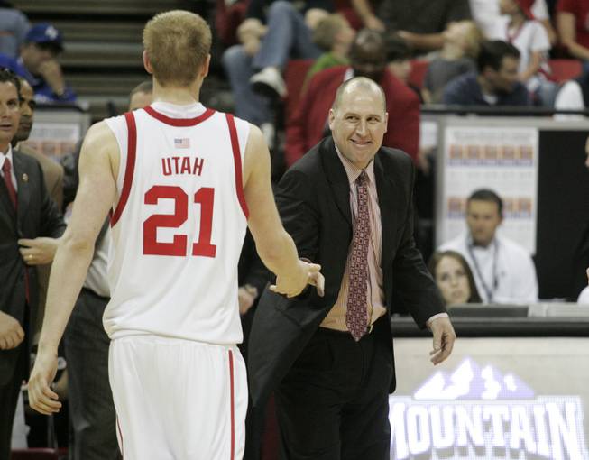 Utah head coach Jim Boylen congratulates forward Shaun Green in the closing minutes against San Diego State during the championship game of the Mountain West Conference Basketball Championships Saturday.  Utah won 52-50 for an automatic trip to the NCAA Tournament. 