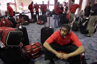Oscar Bellfield sits on his bag as the UNLV Rebels wait to check in at McCarran International Airport on Tuesday, March 16, 2010. The Rebels headed off to take on 9-seed Northern Iowa in Oklahoma City in the NCAA tournament.