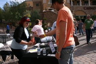 A patron signs in for his wrist band and cup for the first annual MonteLago Craft Beer Festival at the Village at Lake Las Vegas Saturday.