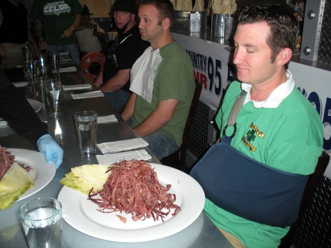 Contestant Randall Morrison eyes the mountain of corned beef that lies in front of him at a corned beef eating contest for St. Patrick's Day Tuesday. Morrison went on the win second place in the contest.