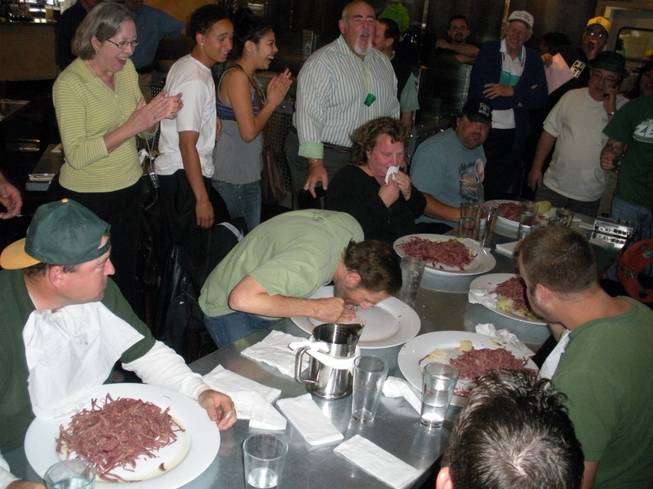 Eating contest winner Rob Koch licks his plate clean at a corned beef eating contest. Morrison went on the win second place in the contest.
