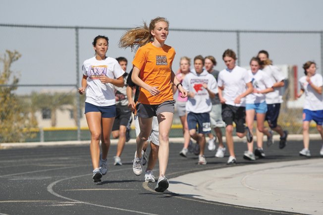 Coronado senior Michaelanne Laurent leads the pack while running the mile with her teammates during cross-country practice.