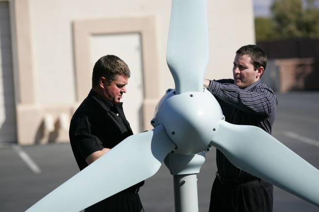 Allen McLane, co-owner of McLane Electric, and project manager Jason McLane assemble a demonstration version of the Skystream wind turbine.  It costs about $20,000 to install and permit the wind turbine.
