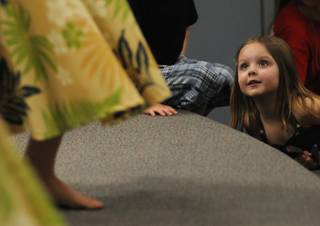 Kiera Cronk, 3, leans in for a closer look at a Hawaiian dancer during a performance of the 2008 Na Hoku Hanohano Award winning recording artist Gary Haleamau at Elise Wolff Elementary School on Thursday night.