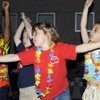 From left to right: Elise Wolff Elementary School kindergarteners Aaron Asare, Austin Cates, Kassidy Krumm and Emelie Sanchez perform basic Hawaiian movements to the song "Live a Little" as they show off traditional dance moves to parents as the school celebrates Multi-cultural Day on Thursday night.