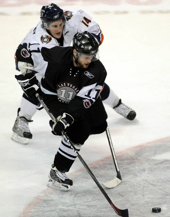 Wranglers forward Dan Riedel (11) carries the puck through center ice while being closely pursued by Ontario Reign winger Bud Holloway during ECHL action at the Orleans Arena on March 20.
